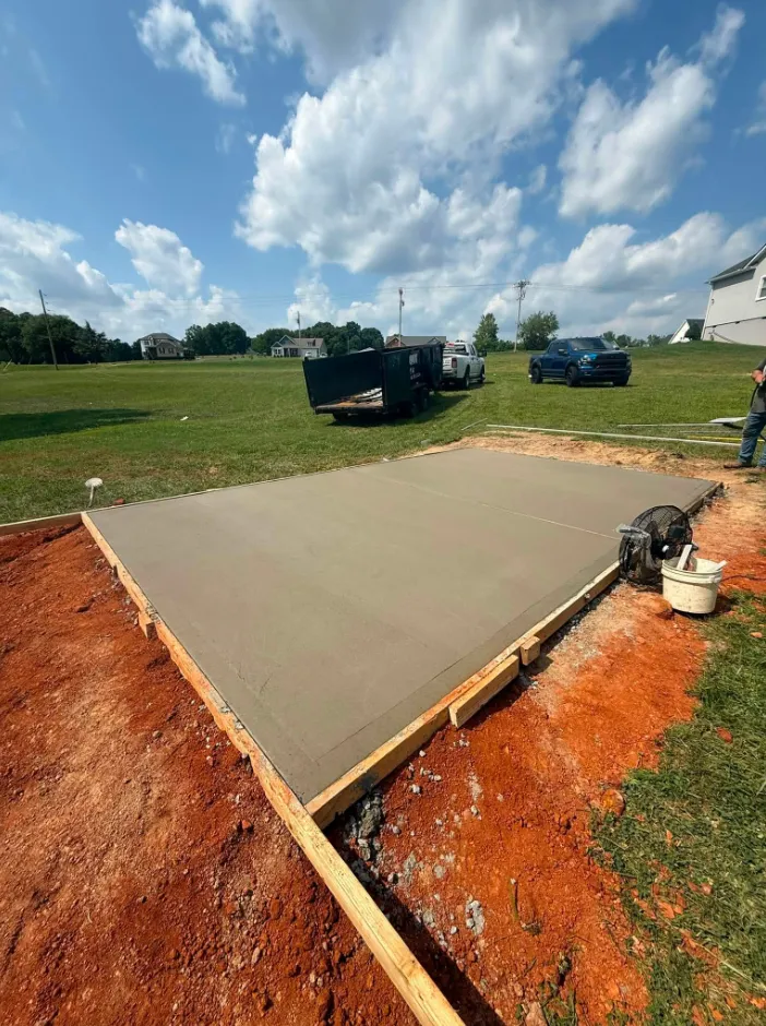 Freshly poured concrete driveway extension